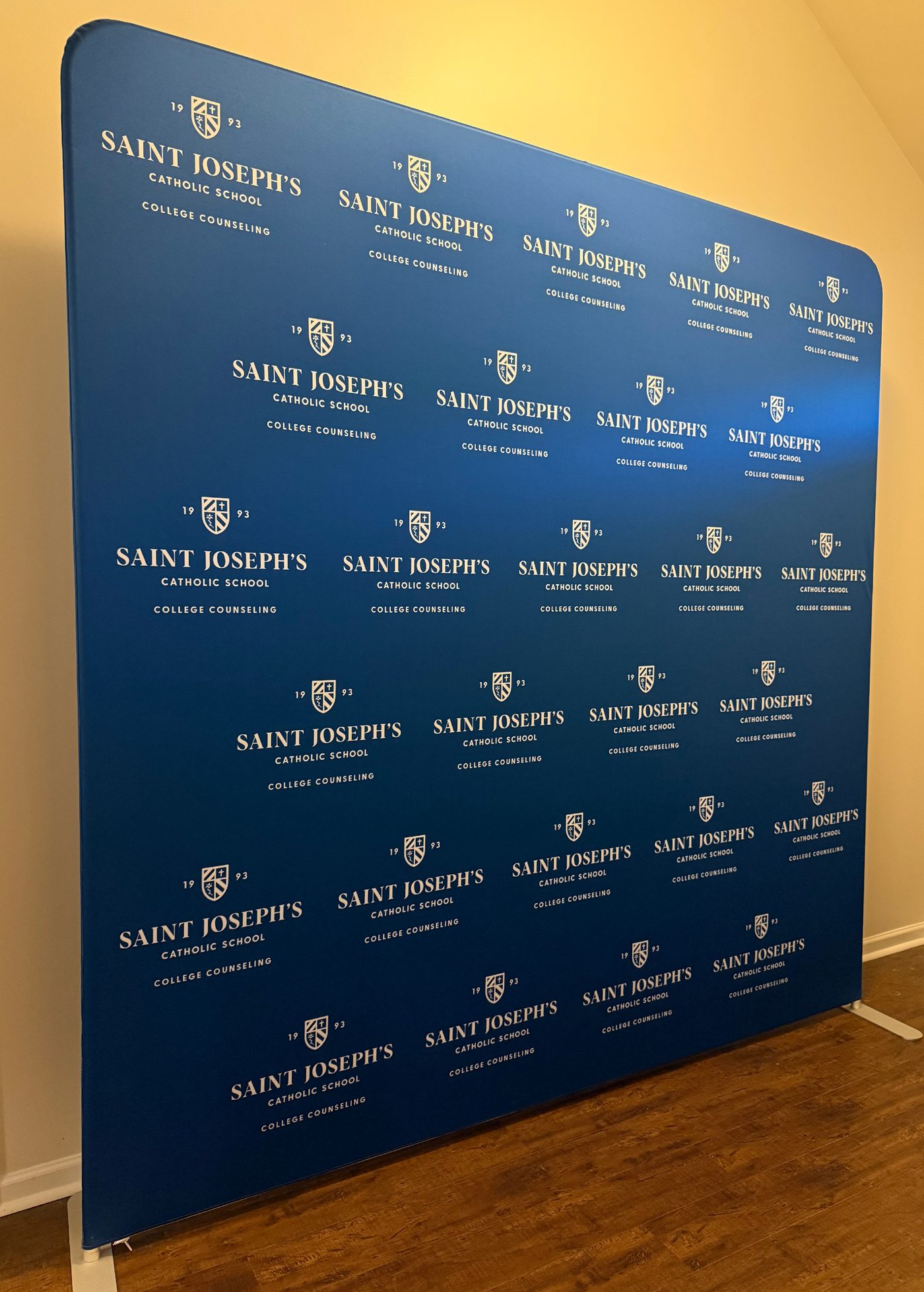 Straight tension fabric step-and-repeat backdrop printed for a school event